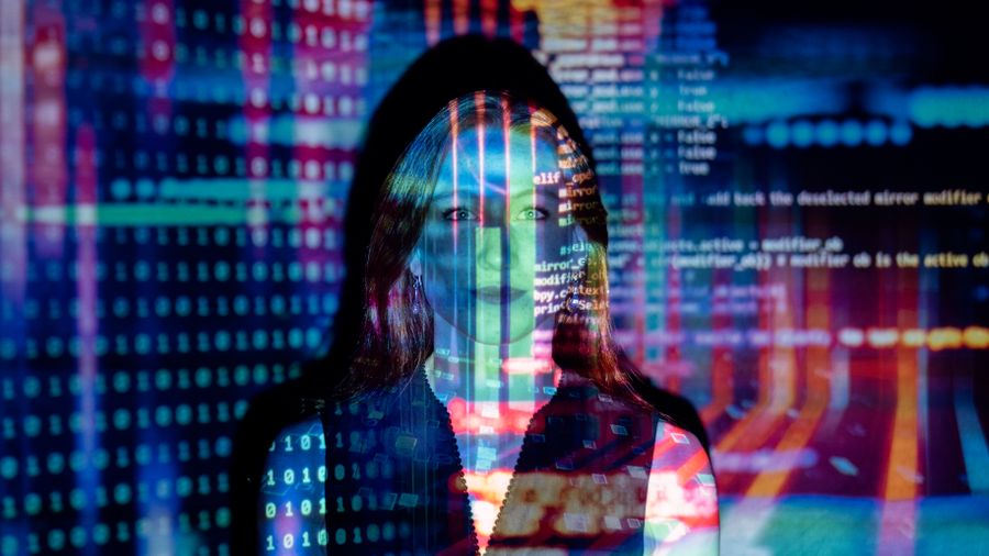 AI engineer working with code reflected in an office window