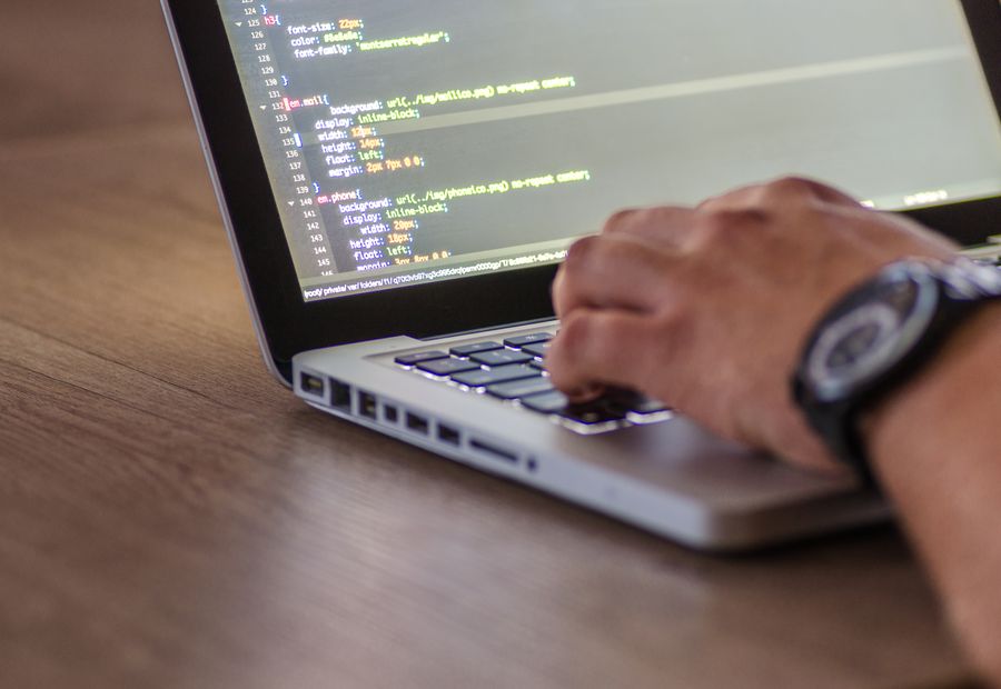 Software engineer writing production code on a laptop
