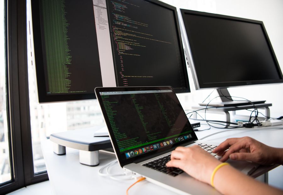 Developer reviewing application code on a monitor